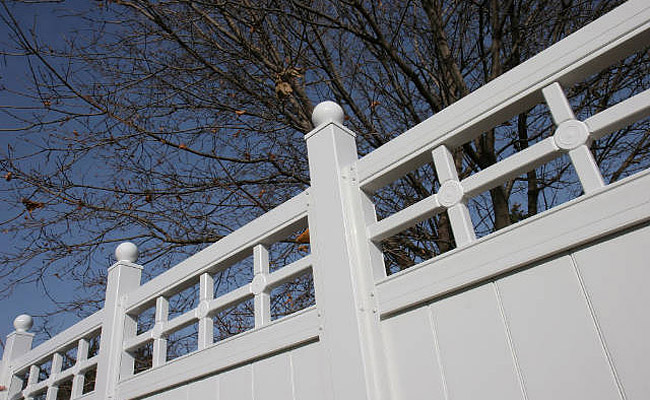 vinyl fence and gates beside home