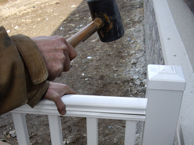 using hammer to install railing
